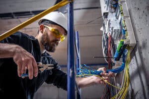Commercial electrician working on a consumer unit.